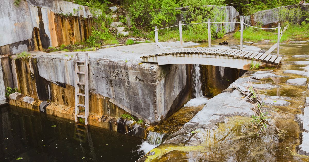 View of Dorset Marble Quarry foot bridge, ladder and small waterfalls.